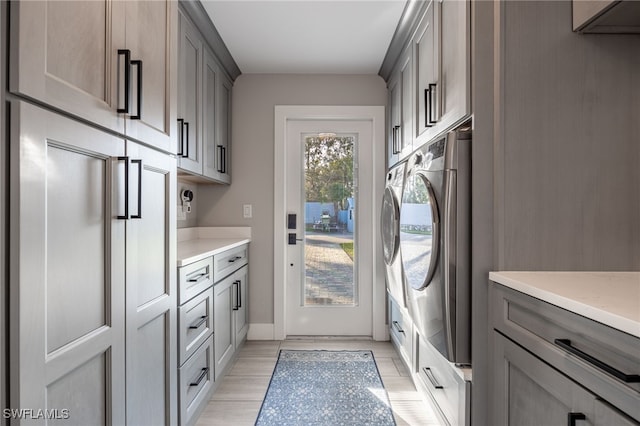 laundry room with cabinets and washer / clothes dryer