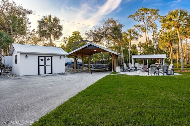 exterior space with an outdoor structure, a patio, a gazebo, and a lawn