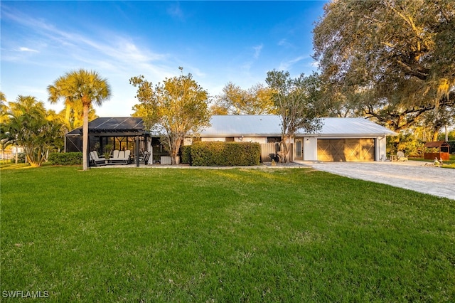 ranch-style home with a garage, glass enclosure, and a front yard