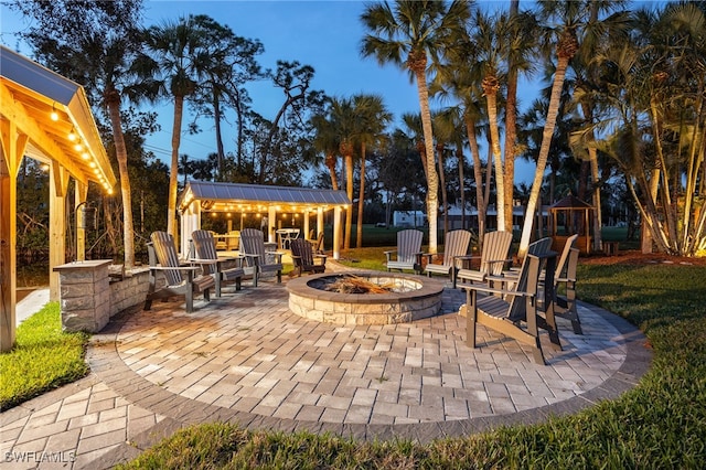 view of patio with an outdoor fire pit and a gazebo