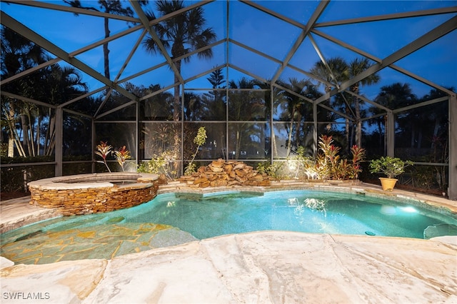 outdoor pool featuring an in ground hot tub, a patio area, and a lanai