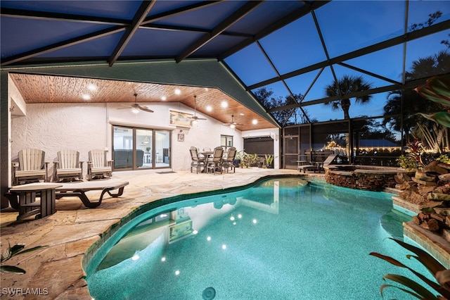 pool at dusk with a patio, ceiling fan, and glass enclosure