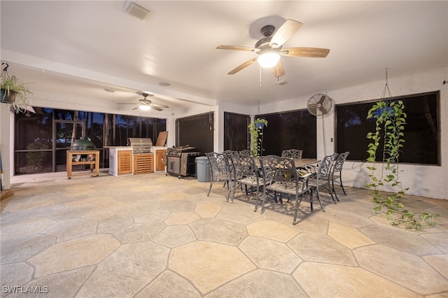 view of patio featuring ceiling fan, visible vents, exterior kitchen, grilling area, and outdoor dining space