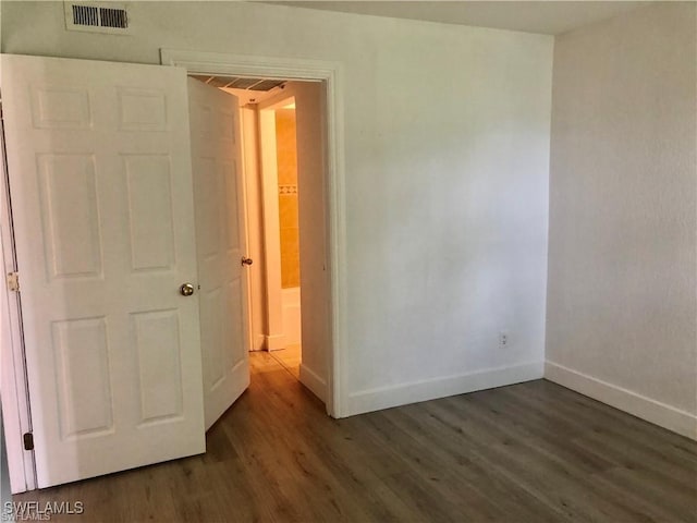 spare room featuring dark hardwood / wood-style floors