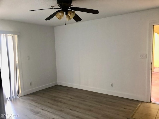 unfurnished room featuring ceiling fan and hardwood / wood-style floors