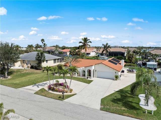 view of front of property with a garage and a front lawn