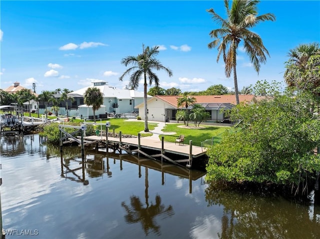 view of dock featuring a water view and a yard