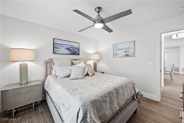 bedroom with hardwood / wood-style floors and ceiling fan