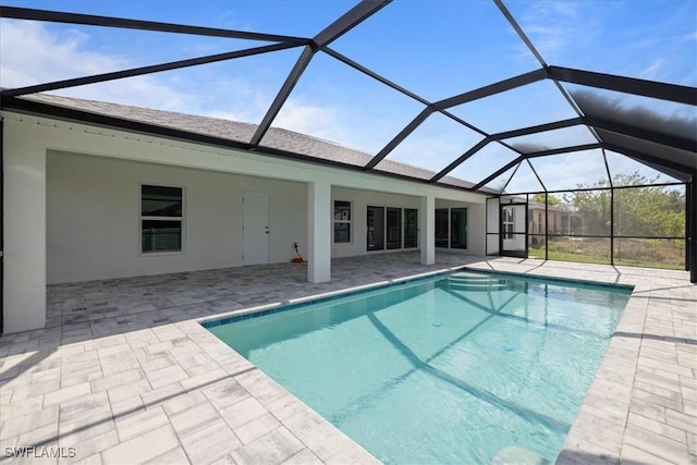 view of swimming pool with a lanai and a patio area