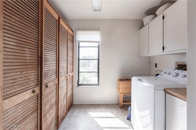 laundry room with baseboards, cabinet space, and washer and dryer