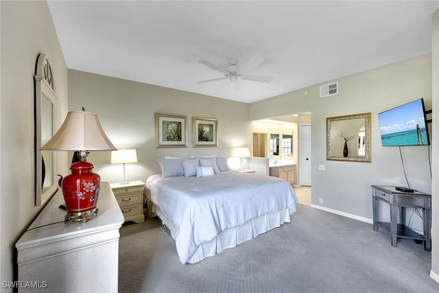 bedroom featuring ceiling fan, carpet floors, and ensuite bath