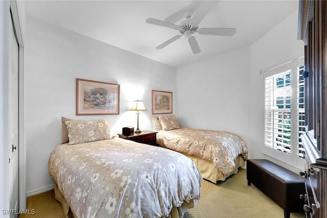 bedroom featuring ceiling fan and light colored carpet