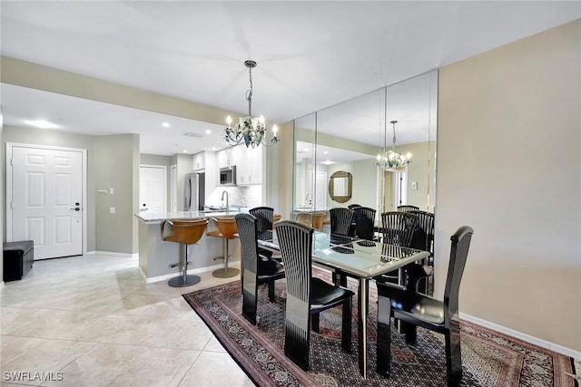 tiled dining area featuring sink and an inviting chandelier