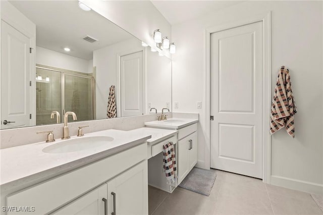 bathroom with vanity, an enclosed shower, and tile patterned flooring