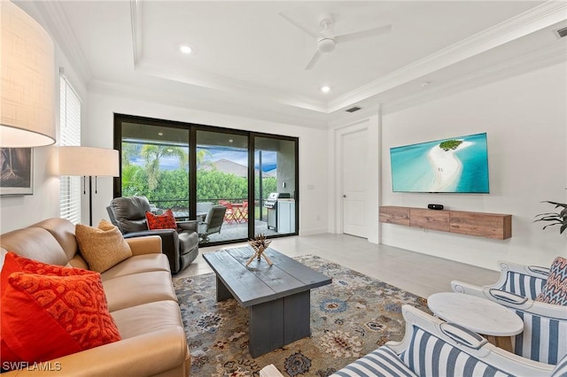 living room with crown molding, a raised ceiling, and ceiling fan