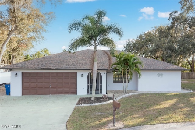 single story home with concrete driveway, an attached garage, and stucco siding