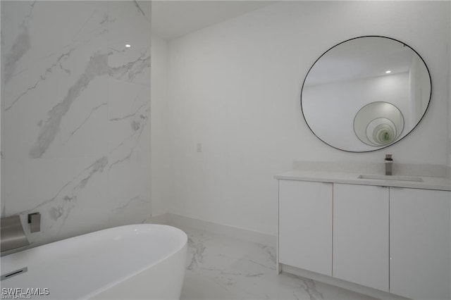 bathroom featuring vanity and a bath