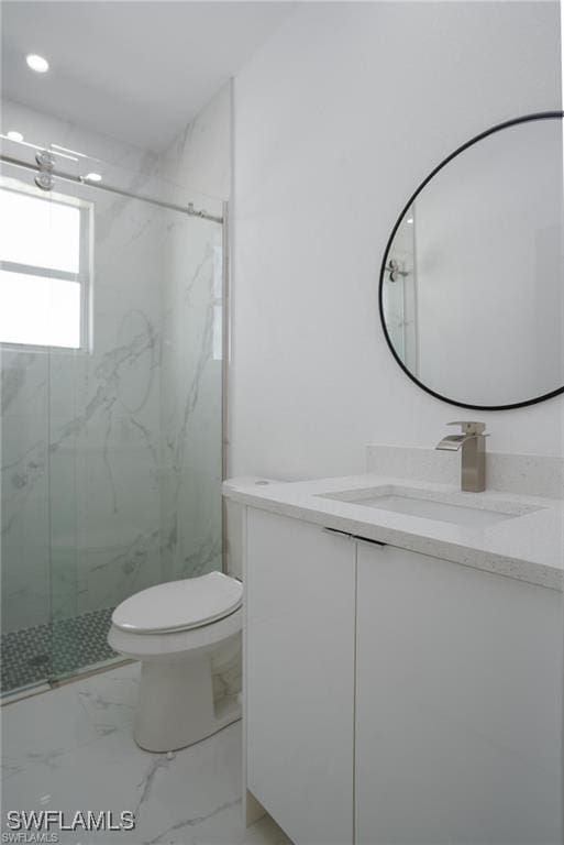 bathroom with walk in shower, vanity, and toilet