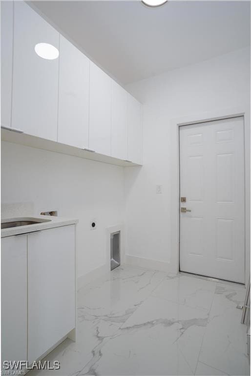 laundry area with cabinets and hookup for an electric dryer