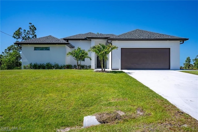 view of front of house with a garage and a front yard