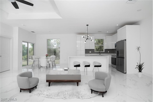 living room with sink and a notable chandelier