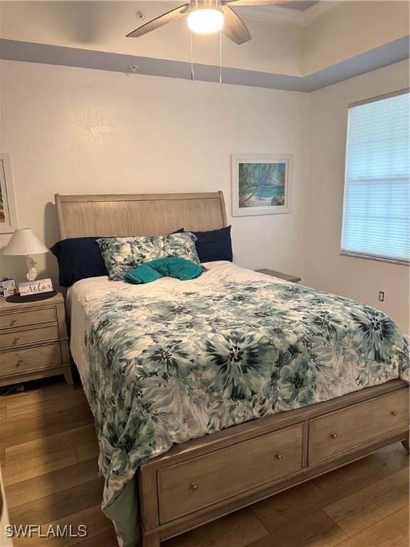 bedroom with dark wood-type flooring and ceiling fan