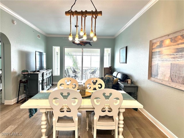 dining area with ornamental molding and wood-type flooring