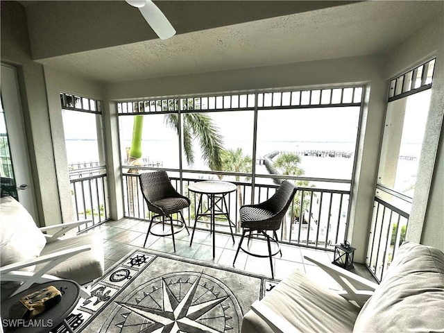 sunroom / solarium featuring ceiling fan