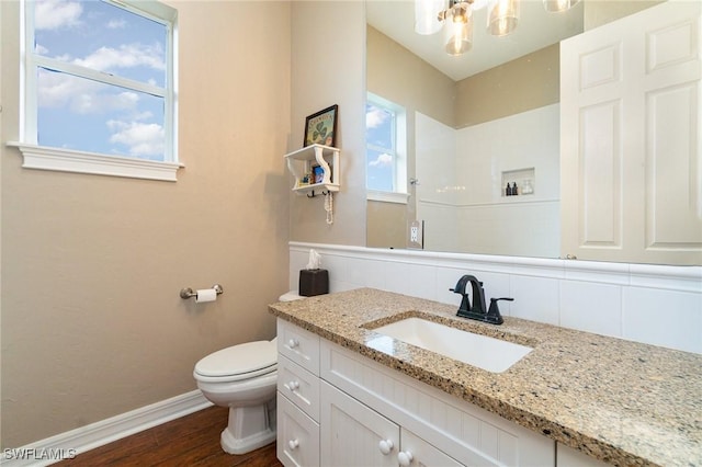 bathroom with hardwood / wood-style flooring, vanity, toilet, and backsplash