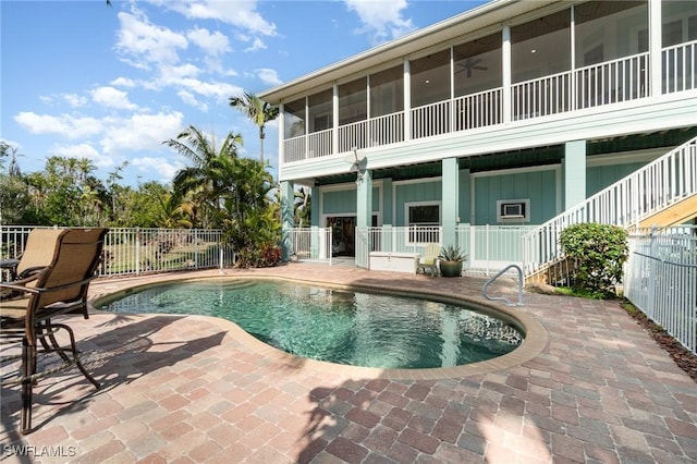 view of swimming pool with a sunroom, a patio, and ceiling fan