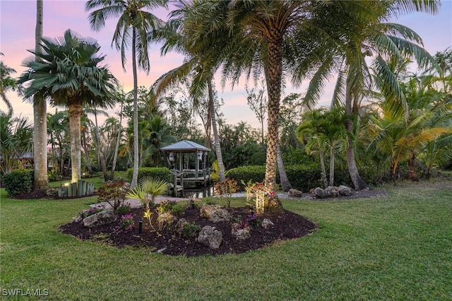 yard at dusk with a gazebo