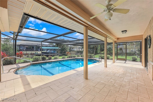 view of pool with a lanai, ceiling fan, and a patio area