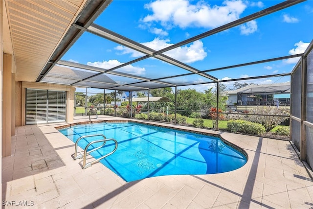 view of pool with a patio and glass enclosure