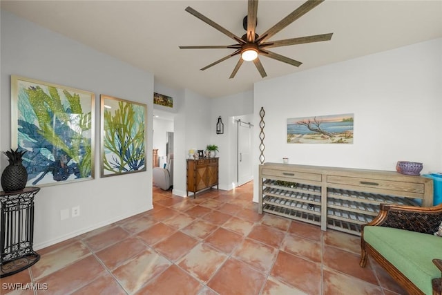 living area featuring tile patterned floors and ceiling fan