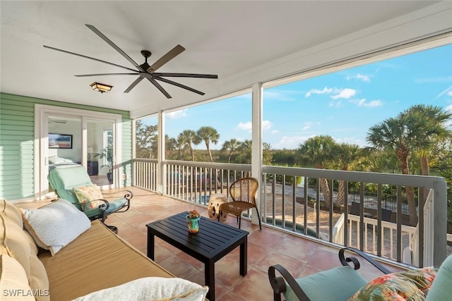 sunroom / solarium with a healthy amount of sunlight and ceiling fan