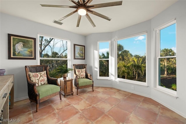 sitting room featuring light tile patterned floors and ceiling fan