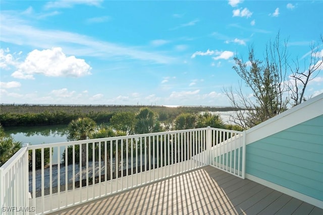 wooden terrace featuring a water view