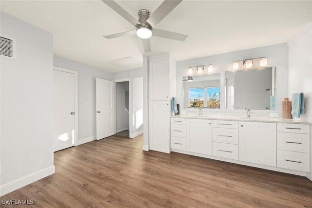 bathroom featuring vanity, hardwood / wood-style floors, and ceiling fan