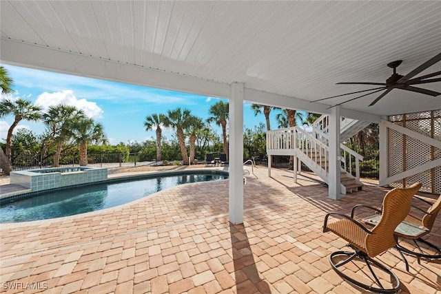 view of swimming pool with a patio, ceiling fan, and an in ground hot tub