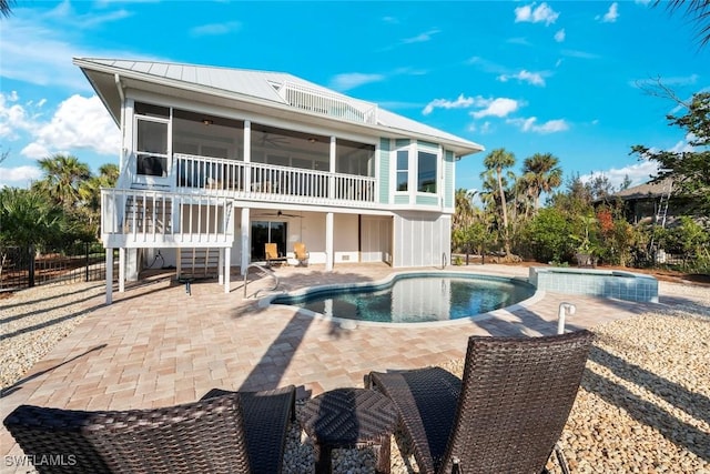 back of property featuring a patio, a sunroom, and ceiling fan