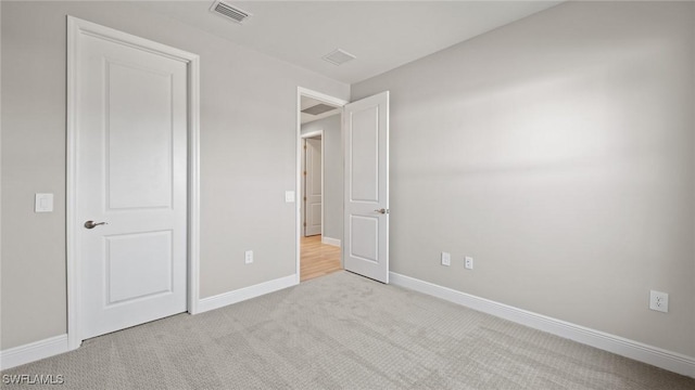 unfurnished bedroom featuring light carpet