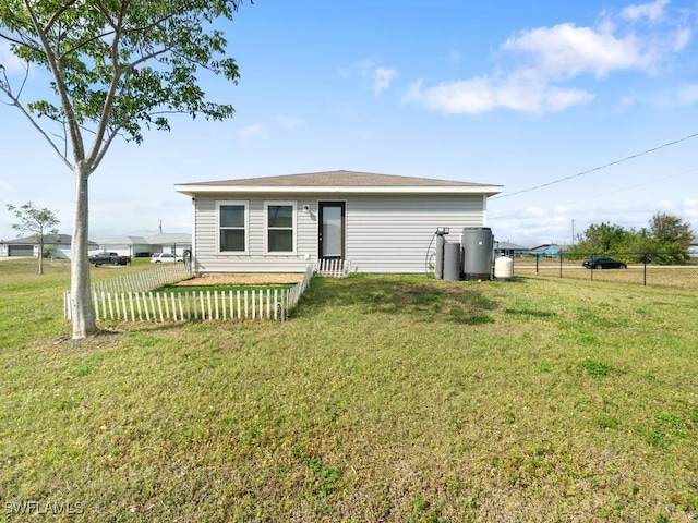 rear view of property with a yard