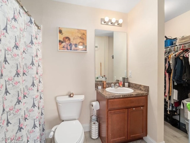 bathroom featuring vanity, a shower with curtain, and toilet