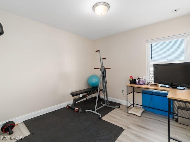 workout room featuring light hardwood / wood-style flooring