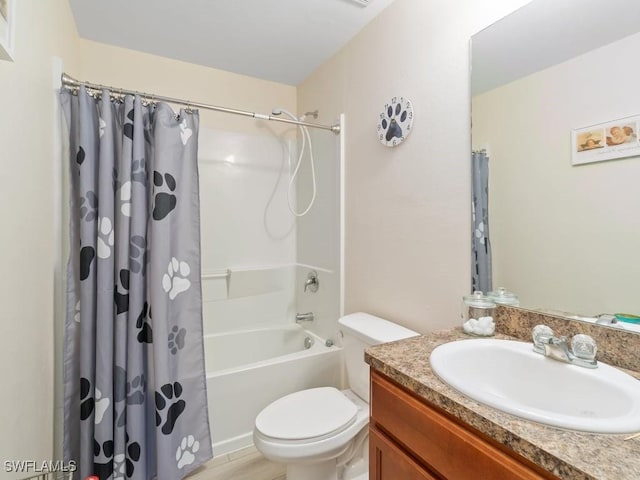 full bathroom with vanity, shower / bath combo with shower curtain, and toilet