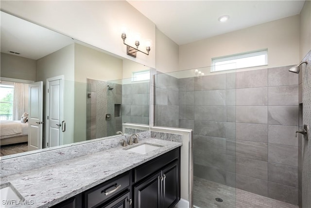 bathroom featuring visible vents, walk in shower, connected bathroom, and vanity