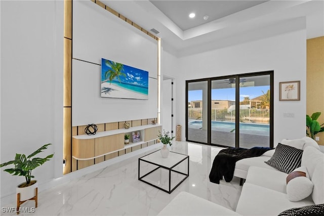 living room featuring recessed lighting, visible vents, and marble finish floor