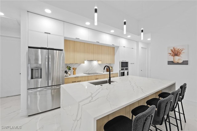 kitchen with a sink, stainless steel appliances, marble finish floor, and modern cabinets