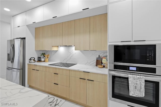 kitchen with modern cabinets, appliances with stainless steel finishes, and light brown cabinetry