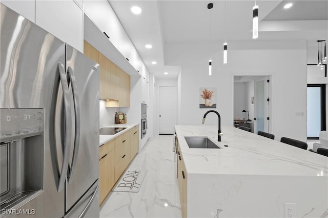 kitchen with an island with sink, stainless steel refrigerator with ice dispenser, marble finish floor, modern cabinets, and a sink